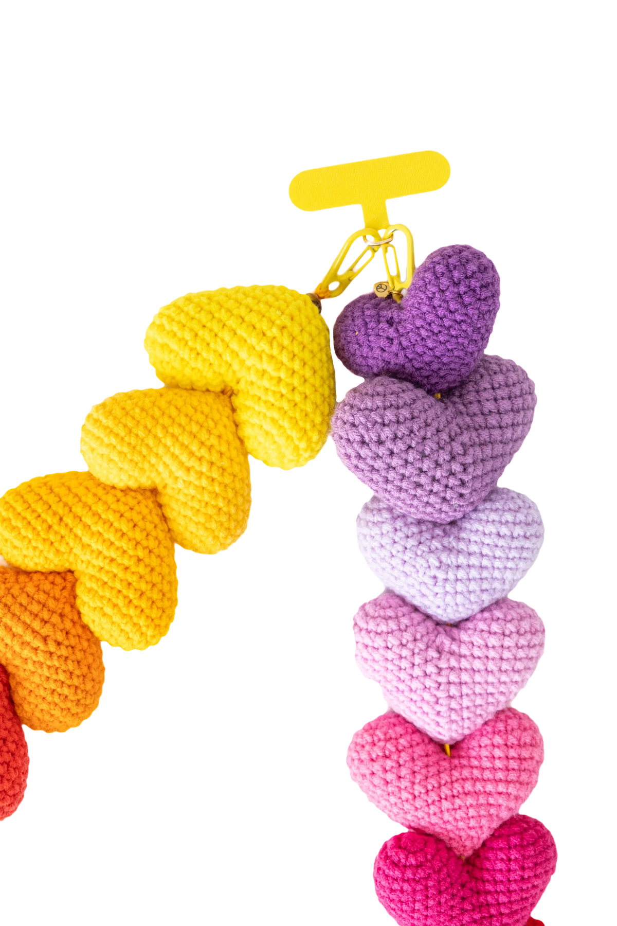Yellow fabric tab and clasp of the long crochet heart phone strap
