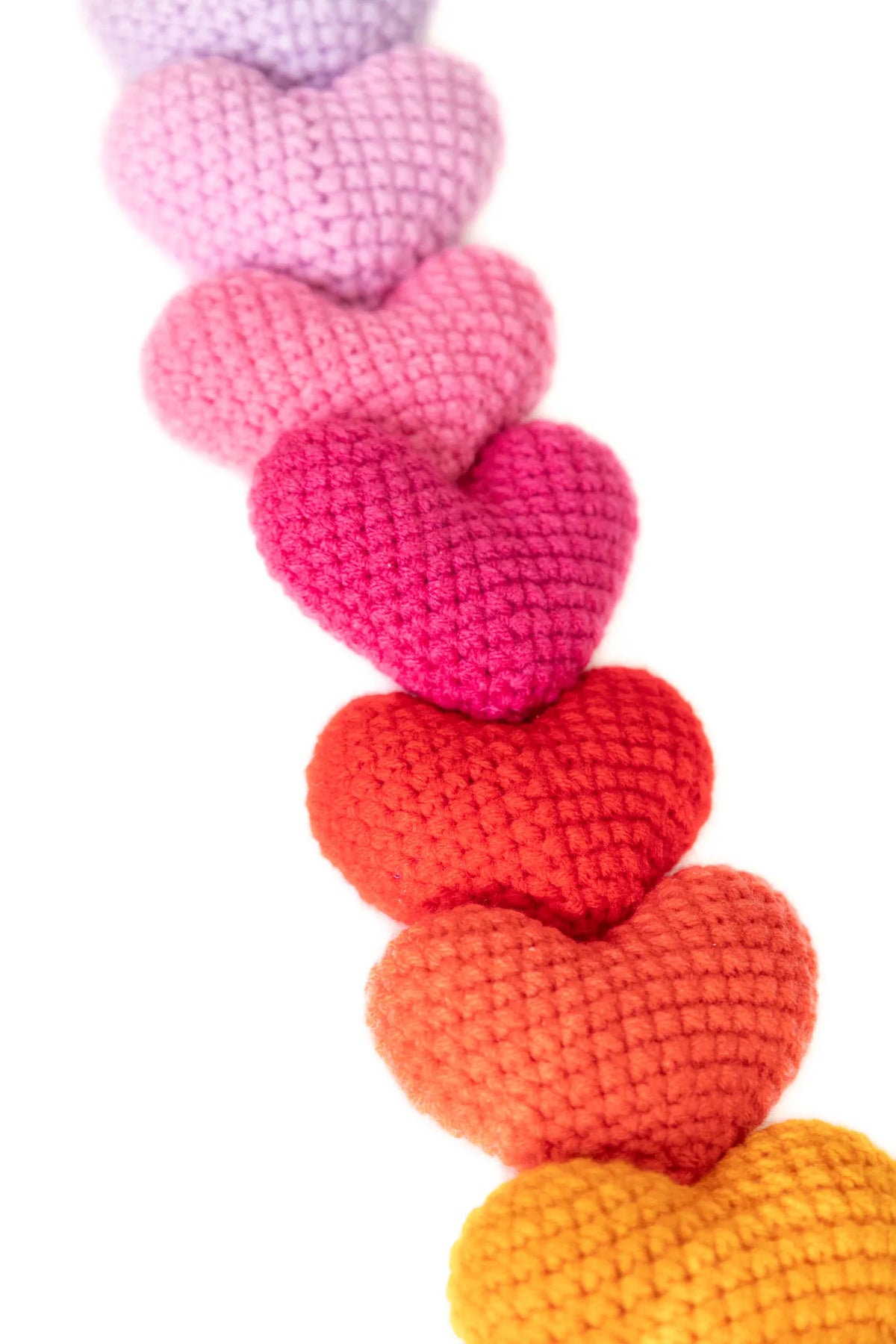 Detail of the oversized pink, red and orange crochet hearts